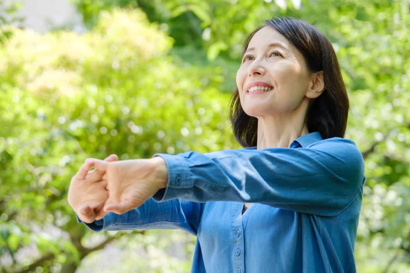smiling woman stretching arms
